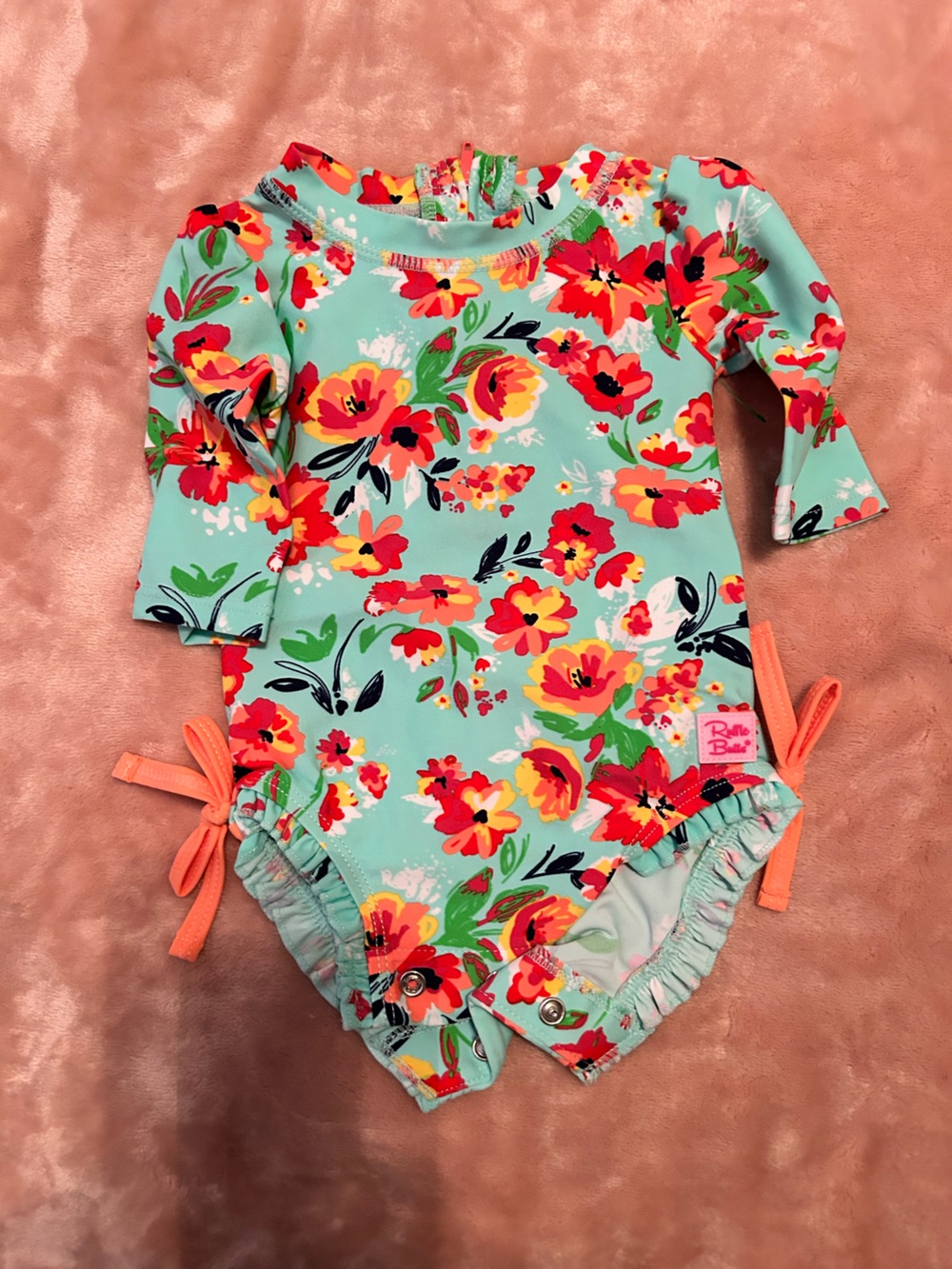 Ruffle Butts Aqua Floral Rashguard Swimsuit with Coral Ties